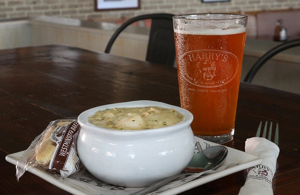 Bowl of clam chowder with pint of beer